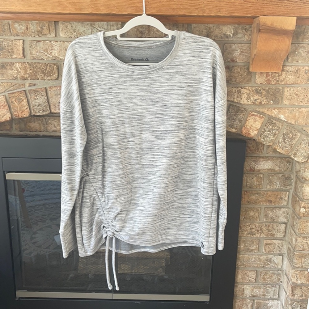Sweater from Reebok. It’s a very light sweater.